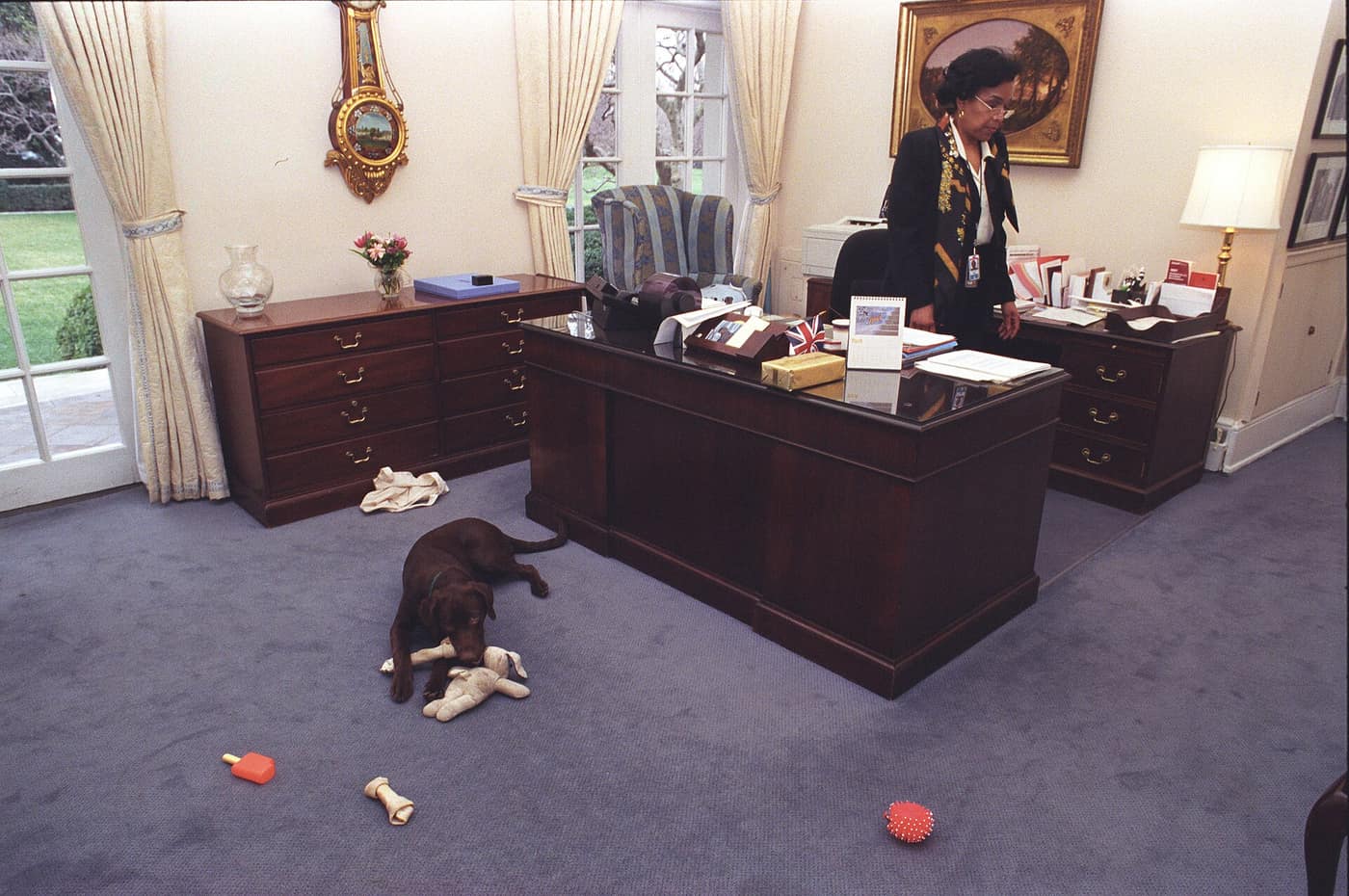 Photograph of Buddy the Dog Playing with Toys in front of Betty Currie's Desk in the Outer Oval Office